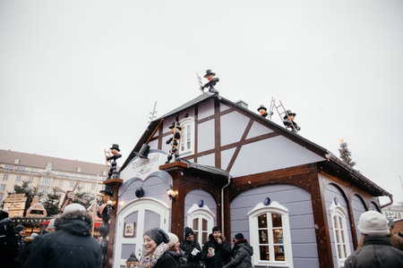 Dresden, Saxony, Germany, 10 December 2022: Christmas outdoor market stall decorations with fairy with lights, pflaumentoffel haus, plum fool man character, half-timbered house with shuttersのeditorial素材