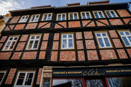 Quedlinburg, Saxony-Anhalt, Germany, 28 October 2022: Historic old vintage colored timber frame houses in medieval town, UNESCO World Heritage city, half-timbered home at sunny autumn day, cobblestoneのeditorial素材