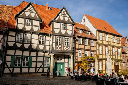 Quedlinburg, Saxony-Anhalt, Germany, 28 October 2022: Historic old vintage colored timber frame houses in medieval town, UNESCO World Heritage city, half-timbered home at sunny autumn day, cobblestoneのeditorial素材