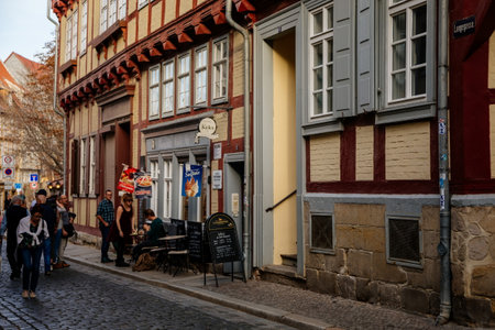 Quedlinburg, Saxony-Anhalt, Germany, 28 October 2022: Historic old vintage colored timber frame houses in medieval town, UNESCO World Heritage city, half-timbered home at sunny autumn day, cobblestoneのeditorial素材