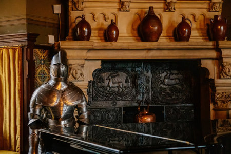 Wernigerode, Saxony-Anhalt, Germany, 29 October 2022: Romantic castle interiors, knightly armor, vintage wooden chest next to window, baroque and renaissance furniture in large hall, colored plasterのeditorial素材