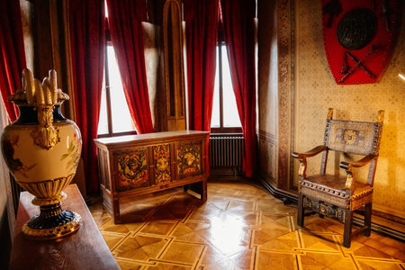 Wernigerode, Saxony-Anhalt, Germany, 29 October 2022: Romantic castle interiors, knightly armor, vintage wooden chest next to window, baroque and renaissance furniture in large hall, colored plasterのeditorial素材