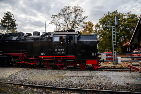 Wernigerode, Germany, 29 October 2022: Steam engine train in Harz Mountains Region, Old retro vintage steam locomotive near railway station at sunny day, white smoke from train chimney, Brocken Lineのeditorial素材