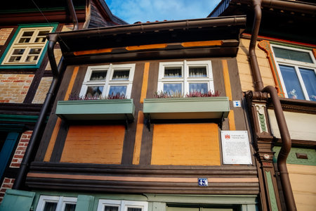 Wernigerode, Saxony-Anhalt, Germany, 29 October 2022: Kleinstes Haus or smallest house, Historic old vintage colored timber frame houses in medieval town, half-timbered home at sunny autumn dayのeditorial素材