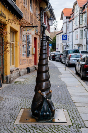 Wernigerode, Saxony-Anhalt, Germany, 29 October 2022: Snail statue, Historic old vintage colored timber frame houses with carvings in medieval town, half-timbered home at sunny autumn dayのeditorial素材