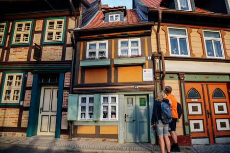 Wernigerode, Saxony-Anhalt, Germany, 29 October 2022: Kleinstes Haus or smallest house, Historic old vintage colored timber frame houses in medieval town, half-timbered home at sunny autumn dayのeditorial素材