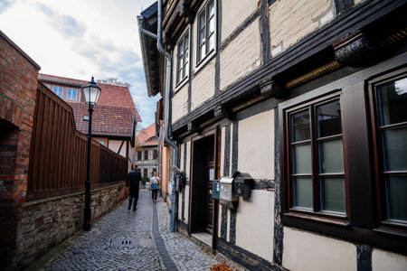 Wernigerode, Saxony-Anhalt, Germany, 29 October 2022: Historic old vintage colored timber frame houses in medieval town, UNESCO World Heritage city, half-timbered home at sunny autumn day, cobblestoneのeditorial素材