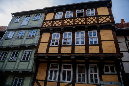 Quedlinburg, Saxony-Anhalt, Germany, 28 October 2022: Historic old vintage colored timber frame houses in medieval town, UNESCO World Heritage city, half-timbered home at sunny autumn day, cobblestoneのeditorial素材