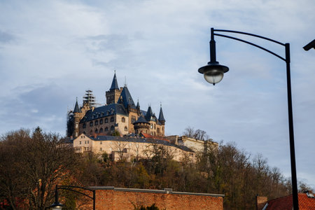 Wernigerode, Saxony-Anhalt, Germany, 29 October 2022: Castle with tower in Harz mountains above town, Neo-Romantic style or historicism, Sculptures of griffins, dragon and eagles, sunny autumn dayのeditorial素材