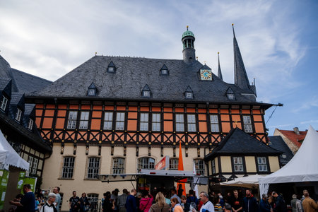 Wernigerode, Saxony-Anhalt, Germany, 29 October 2022: Historic townhall or Rathaus in Market Square, vintage colored timber framed building Fachwerkbau, half-timbered home at sunny autumn dayのeditorial素材