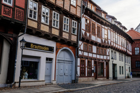 Quedlinburg, Saxony-Anhalt, Germany, 28 October 2022: Historic old vintage colored timber frame houses in medieval town, UNESCO World Heritage city, half-timbered home at sunny autumn day, cobblestoneのeditorial素材