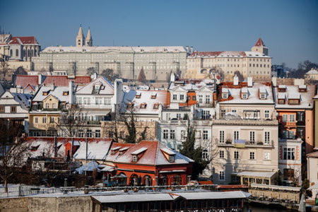 Prague, Czech Republic, 15 December 2022: Lesser Town and Prague castle with towers above River Vltava, View from Charles bridge, snow on roof at sunny winter day, Mala Strana district, UNESCOのeditorial素材