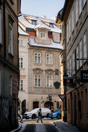 Prague, Czech Republic, 15 December 2022: Lesser Town with Mala Strana district, snow on sunny winter day, red roofs at maltese quarter, baroque palace at narrow Prokopska and Karmelitska streetのeditorial素材