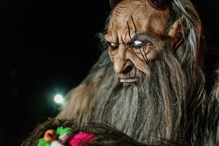 Trutnov, Czech Republic, 17 December 2022: Traditional show Zazij Krampus, parade of masks demonic creatures, devil in flames at winter night, Christmas holidays, fantasy handmade wooden masksのeditorial素材