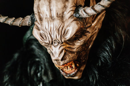 Trutnov, Czech Republic, 17 December 2022: Traditional show Zazij Krampus, parade of masks demonic creatures, devil in flames at winter night, Christmas holidays, fantasy handmade wooden masksのeditorial素材