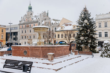 Kolin, Czech Republic, 17 December 2022: Main town Charles square with renaissance historical medieval town hall, Christmas tree decorations, Sgraffito wall decor on facade, snow in winter dayのeditorial素材