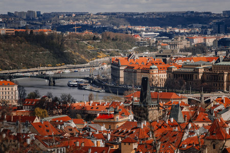 Prague, Czech Republic, 26 March 2023: Panorama of old town from Petrin Hill, Red roofs, Sunny spring day, Vltava river embankment, Rudolfinum concert hall, High spires gothic towers, urban landscapeのeditorial素材