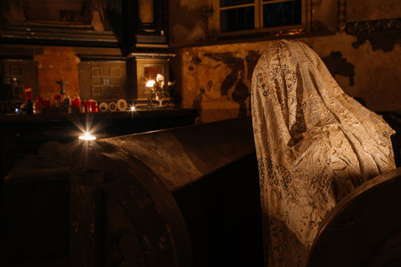 Lukova, Czech Republic, 29 October 2023: Abandoned catholic church of St. George or Jiri, Ghosts line pews, statues by Jakub Hadrava, figures made of plaster, Ghostly figures, Spirit at mass, candleのeditorial素材