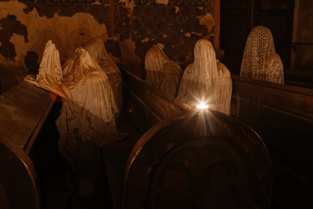 Lukova, Czech Republic, 29 October 2023: Abandoned catholic church of St. George or Jiri, Ghosts line pews, statues by Jakub Hadrava, figures made of plaster, Ghostly figures, Spirit at mass, candleのeditorial素材