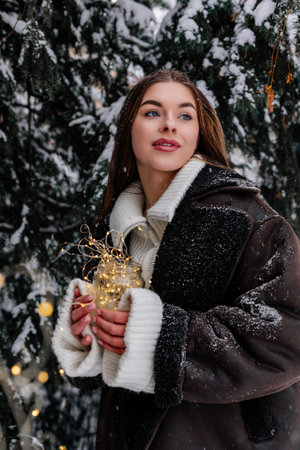 Winter holiday travel, Christmas day, New Year, beautiful happy woman portrait at snowy forest,...