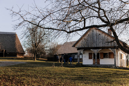Kourim, Bohemia, Czech Republic, 17 December 2023: Traditional village wooden house in autumn and winter, historic country style architecture, Christmas in Skanzen, open air rural ethnographic museumのeditorial素材