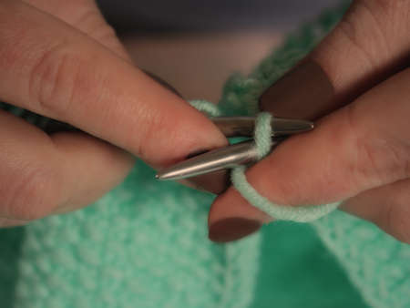 Womans hand knitting scarf, handcraft with steel knitting needlesの写真素材