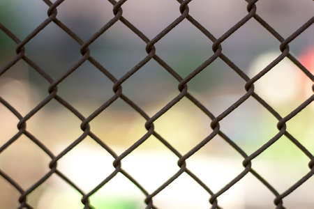Background from a metal unpainted rusty mesh fenceの写真素材