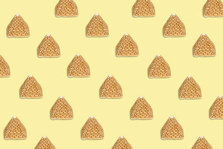 Pattern of golden sand pyramids on a beige background. Minimal tourism background texture. Creative...