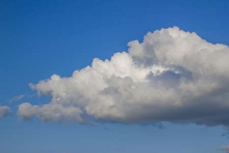 White fluffy clouds on blue sky on a bright sunny summer day.