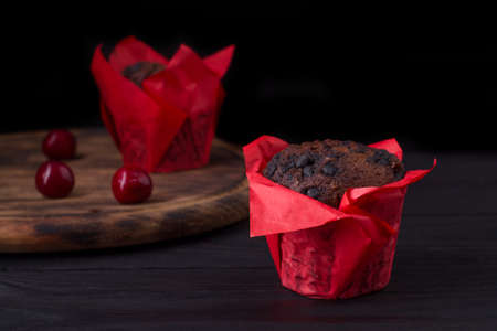 Freshly baked chocolate muffins on a dark background with copy spaceの写真素材