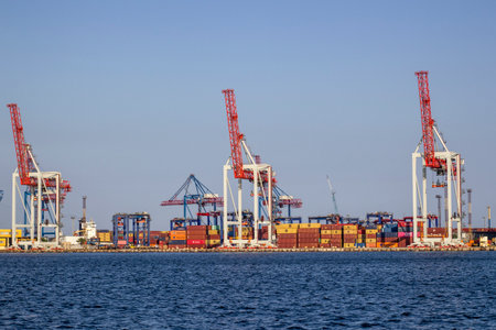 Ukraine, Odessa, summer 2021. Sea industrial commercial port. Container terminal. Cargo container terminal of the sea cargo industrial port. Sea transport, container cranes.のeditorial素材