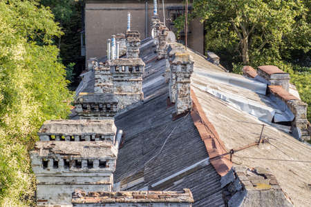 Old roofs of houses with pipes.の写真素材