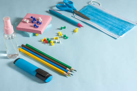 School stationery and medical masks on desk, keep your distance, open schoolの写真素材