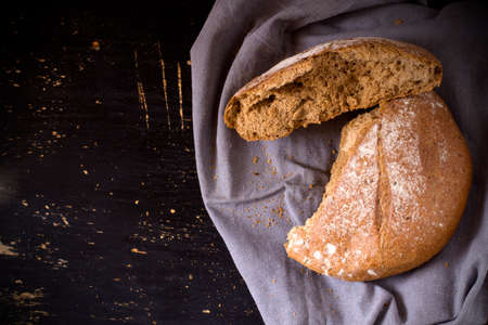 Broken buckwheat bread on dark background. Top view