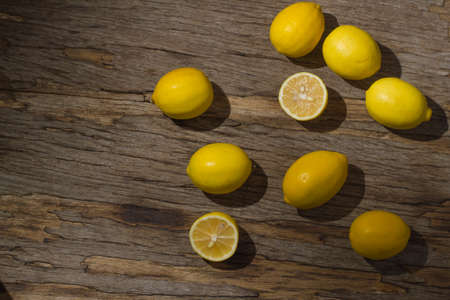Several fresh juicy lemons on wooden background. Meyer varietyの写真素材