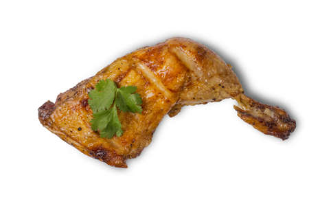 Fried chicken leg with golden brown crust and cilantro leaf isolated on white backgroundの写真素材