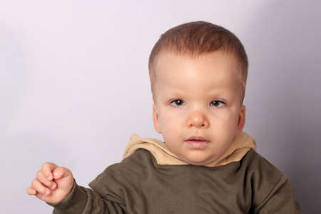 Portrait of a disabled boy with Down syndrome on a light background with copy space. Life is a...
