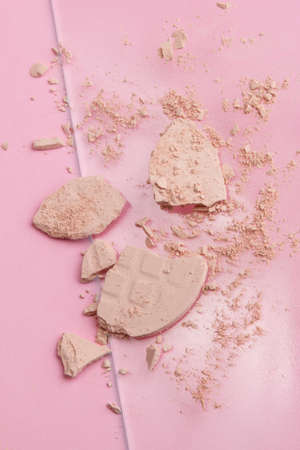 Face powder. Broken pieces of cosmetic powder. Cosmetic smear. Make up a crushed powder.