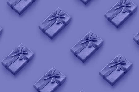 Color Of The Year 2022 - Very Peri. Pattern of gift boxes tied with ribbon.