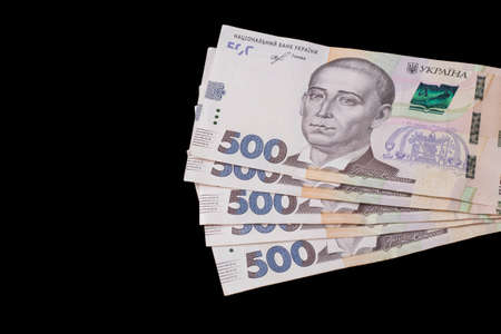The Ukrainian national currency is the hryvnia. Several new 500 hryvnia UAH bills on a black...