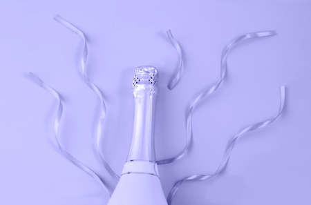 Champagne bottle with ribbons on background in trendy color 2022 very peri.の写真素材