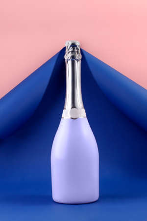 Very Peri champagne bottle on blue paper background.の写真素材