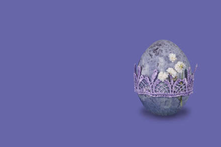 Vintage marble easter egg on trendy very peri background with copy space