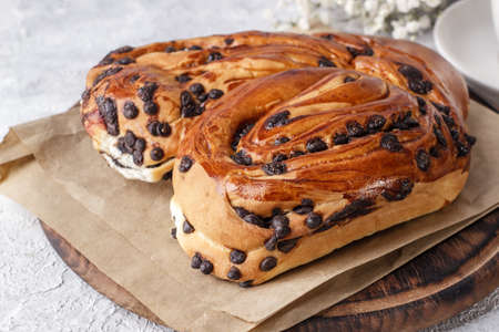 Sweet bun with chocolate drops close-up.の写真素材