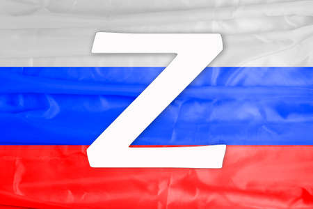 Symbol Z on the background of the Russian flag. The sign is applied to Russian military equipment. Russian military special operation on the territory of Ukraine.の写真素材