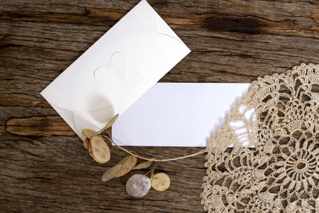 Mockup with a blank rectangular sheet of paper and an envelope on a wooden table. Template for...