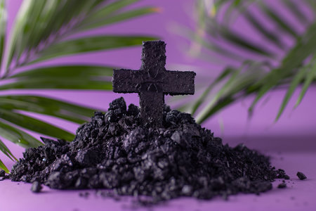 Charcoal Cross on Ashes with Purple Background and Palm Frondsの素材
