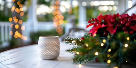 Festive candle and poinsettia arrangement on a wooden table with twinkling lights in the background. Concepts of holiday decor, cozy ambiance, and seasonal celebrations.の素材