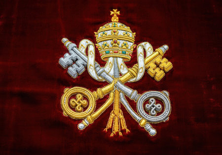 Embroidered Vatican insignia with papal tiara and crossed keys on velvet background.の写真素材