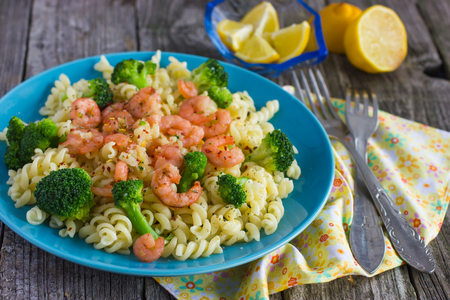 pasta wiht broccoli and shrimps on a wooden backgroundの写真素材